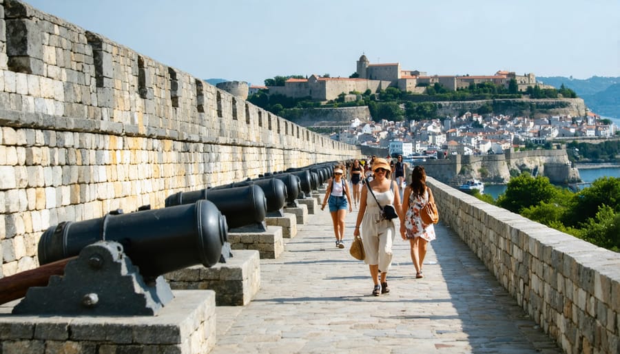 Visitors exploring Quebec City's historic fortification walls with period cannons and panoramic views of the city