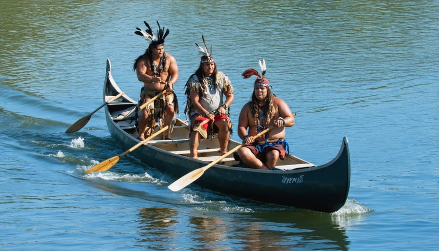 Indigenous tour guides leading a small group in traditional canoes through pristine Ontario lakes