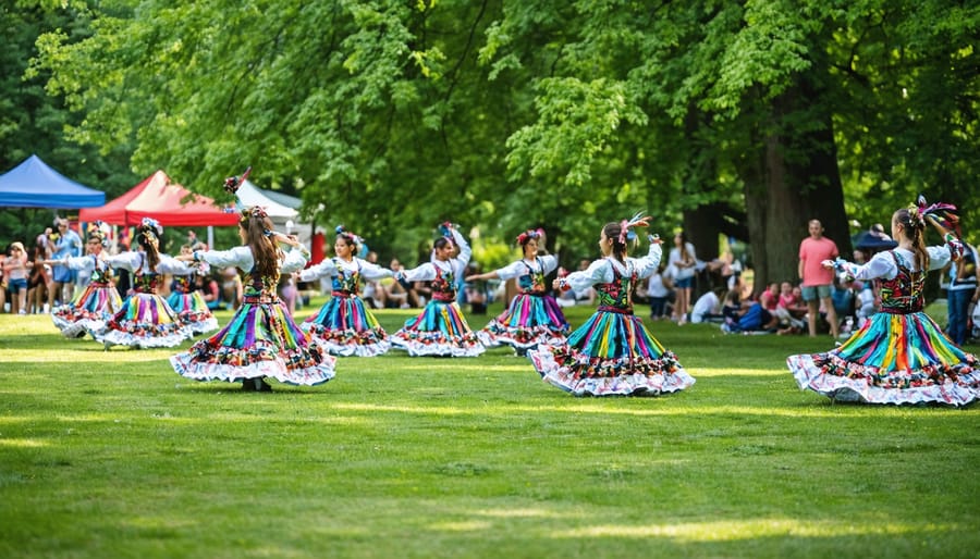 Family sitting on picnic blanket watching cultural dance performance in park during sunset