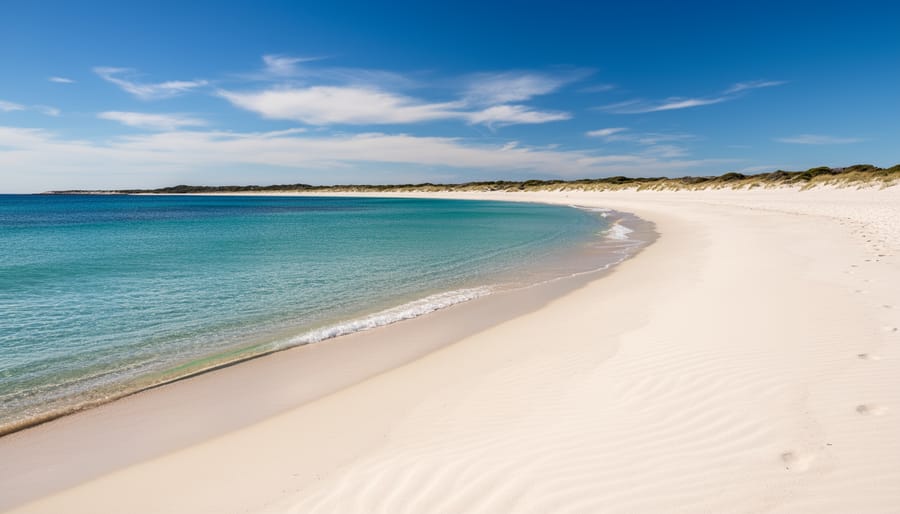 Turquoise water and pale sand shoreline at Singing Sands Beach